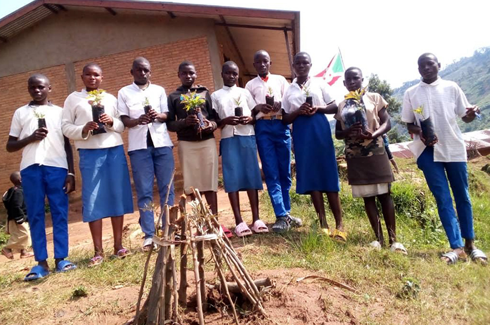Students of Nyenkarange Blue School hold tree seedlings for planting, following sensitisation on natural resource conservation and biodiversity management - marking a practical step toward youth-led environmental stewardship.